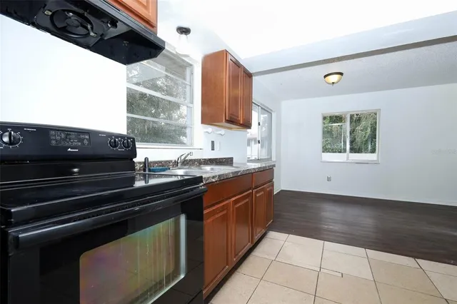 a kitchen with a sink a stove and cabinets