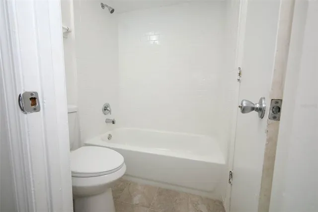 a bathroom with a toilet and shower