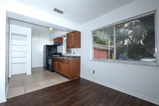 a kitchen with a refrigerator and window