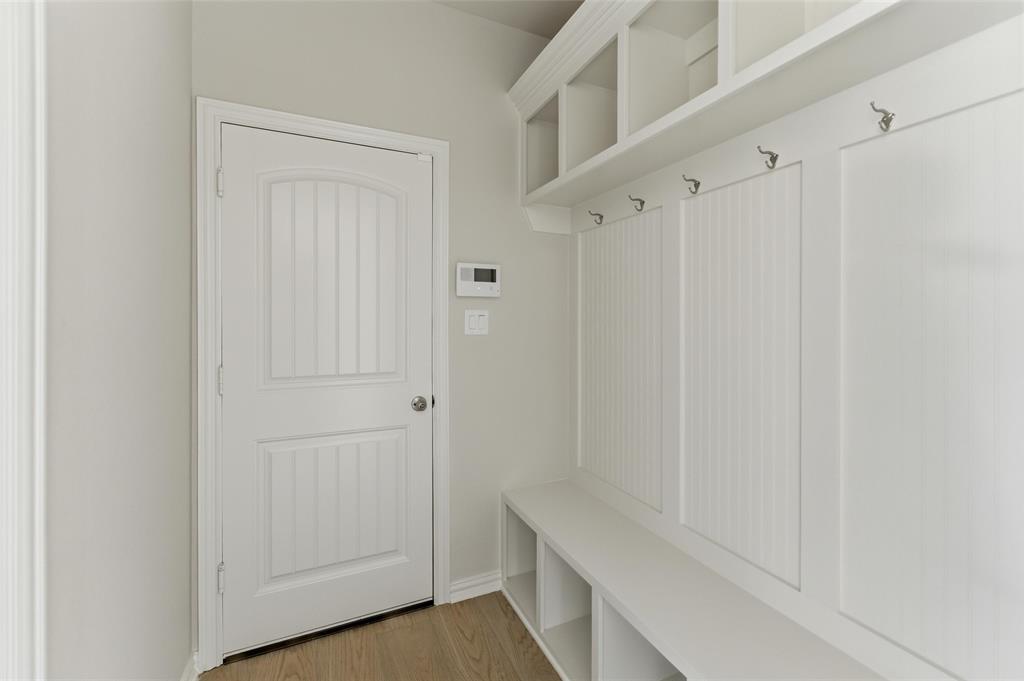 1221 Sabine River Lane Springtown, TX 76082 - Photo 10 of 25 Mudroom featuring light wood-style flooring and baseboards