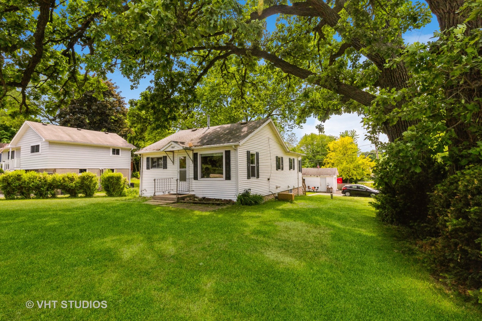 11902 256th Avenue Trevor, WI 53179 - Photo 1 of 10 a view of a white house in front of a big yard with large trees