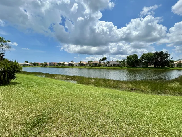 a view of a lake with houses in the back