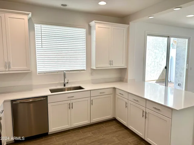 a kitchen with a sink cabinets and window
