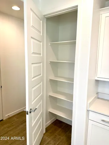 a view of walk in closet with empty racks