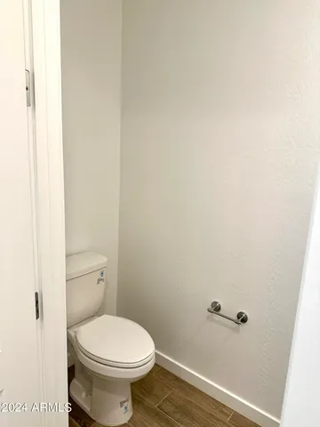 a white toilet sitting next to a shower