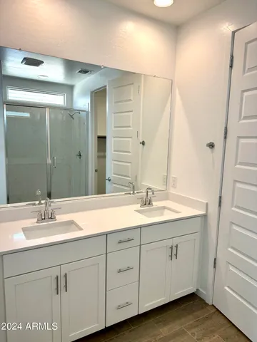 a bathroom with a double vanity sink and mirror