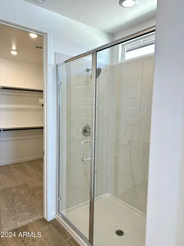 a bathroom with a glass shower door