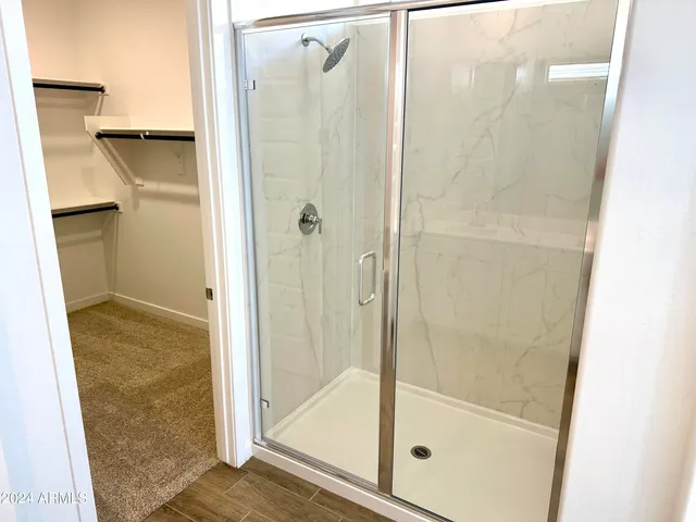 a bathroom with a glass shower door