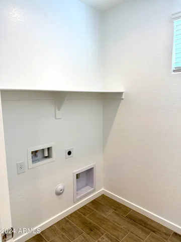 a room with a wooden floor and white walls