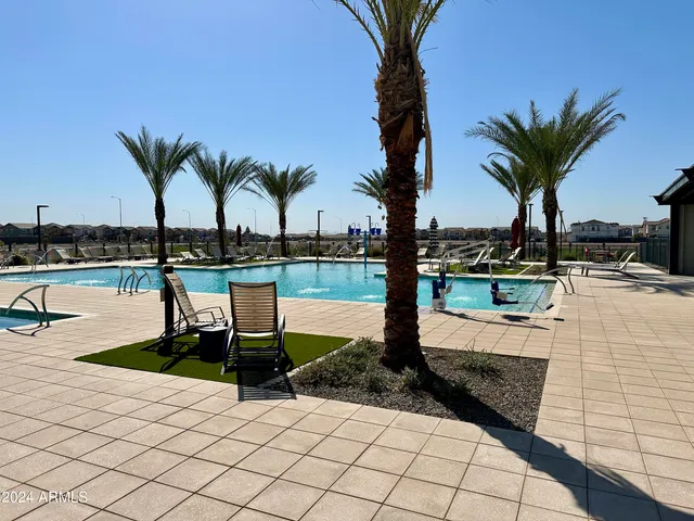 a view of a swimming pool with a table and chairs
