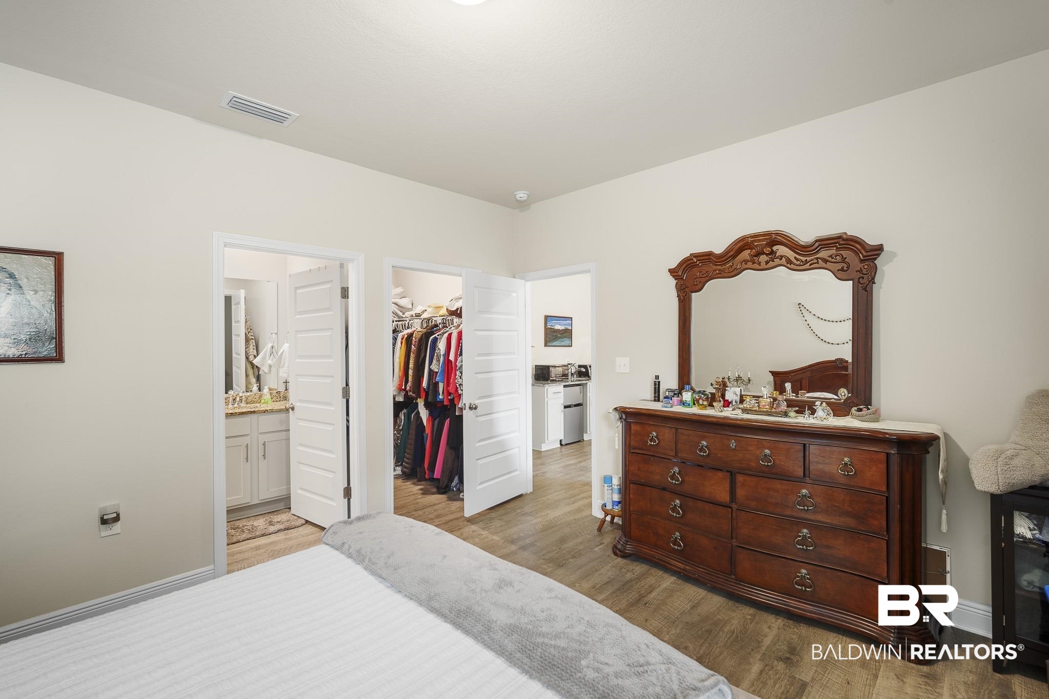 24765 Spectacular Bid Loop Daphne, AL 36526 - Photo 29 of 45 Bedroom featuring ensuite bath, a spacious closet, light hardwood / wood-style floors, and a closet