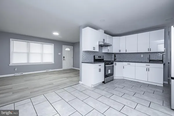 a kitchen with a stove a sink and a refrigerator