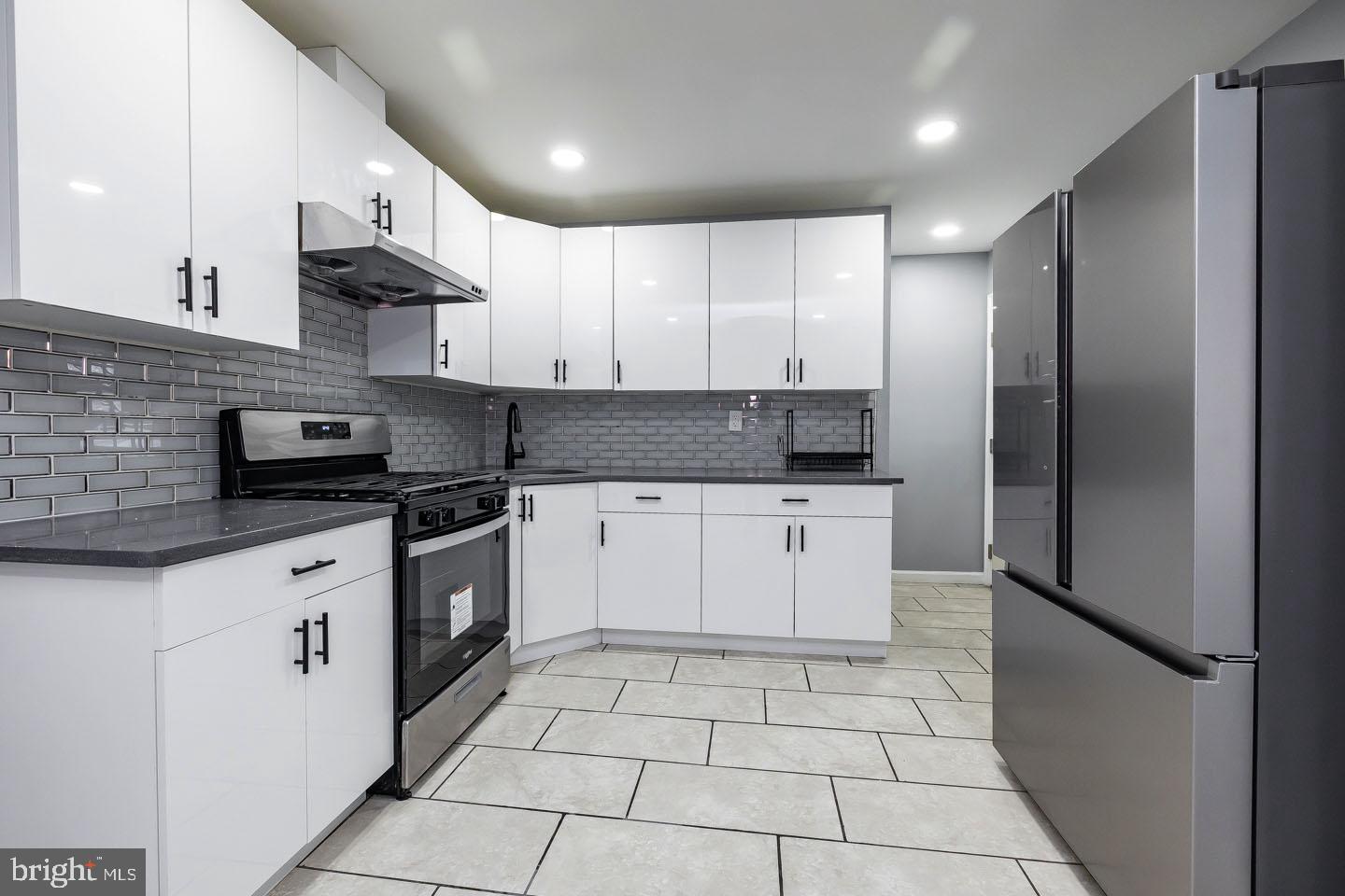 2 Cardinal Road Millville, NJ 08332 - Photo 12 of 39 a kitchen with a sink a refrigerator and cabinets