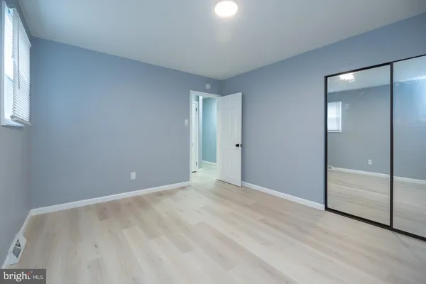 an empty room with sliding door and mirror