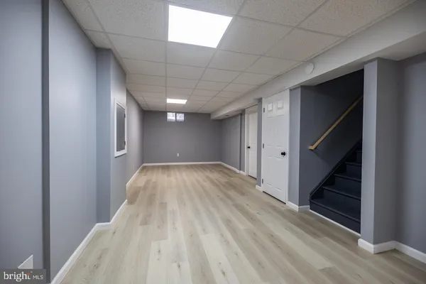 a view of hallway with stairs and wooden floor