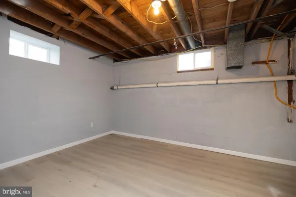 a view of a room with wooden floor and windows
