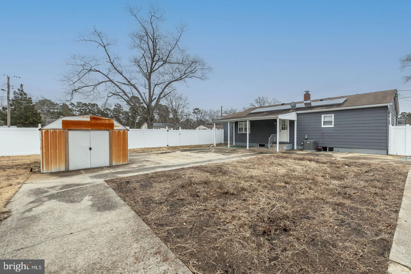 2 Cardinal Road Millville, NJ 08332 - Photo 37 of 39 a backyard of a house with large trees and covered by wooden fence