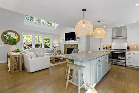 a living room with fireplace furniture and a large window