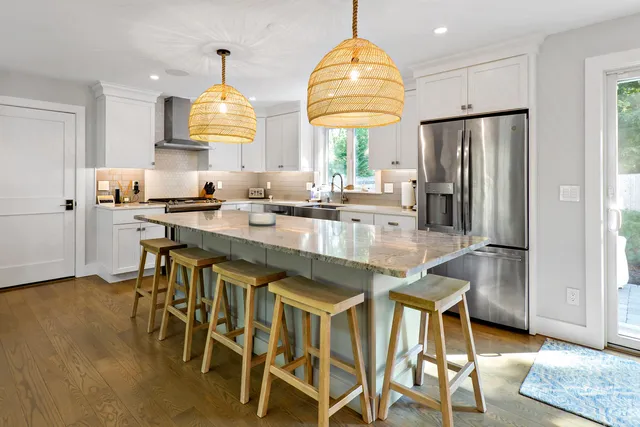 a kitchen with stainless steel appliances granite countertop a sink a stove and a refrigerator