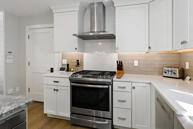 a kitchen with granite countertop a stove and a sink