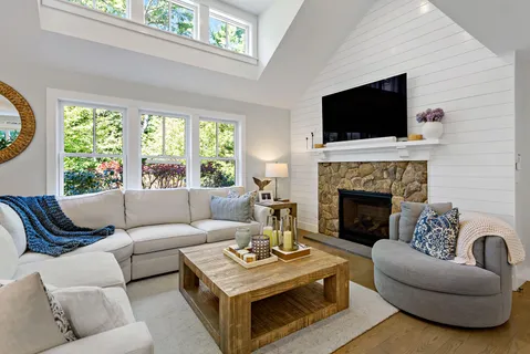 a living room with furniture a flat screen tv and a fireplace