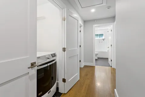 a view of a hallway with wooden floor