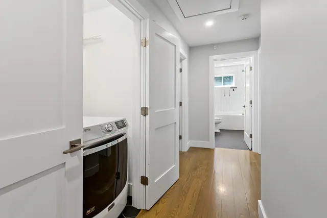 a view of a hallway with wooden floor