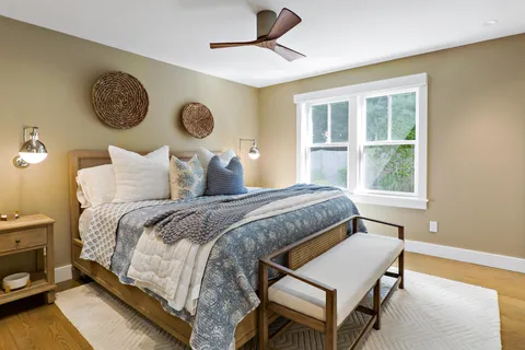 a bedroom with a bed and a window