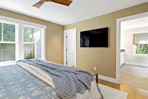 a bedroom with a bed and flat screen tv