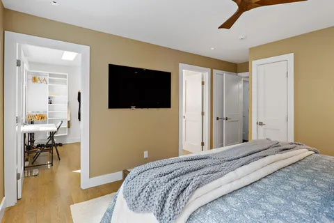 a bedroom with a bed and a flat screen tv