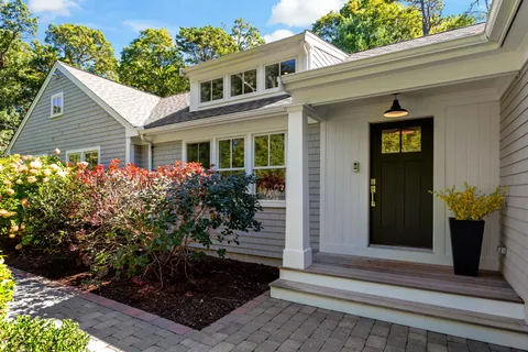 a front view of a house with garden