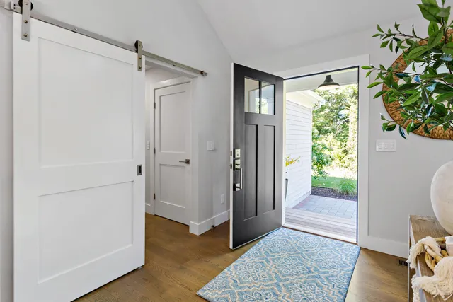a view of a bedroom with wooden floor and a bed