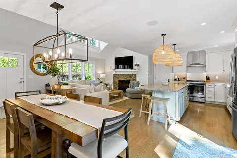 a view of a dining room with furniture a chandelier and wooden floor