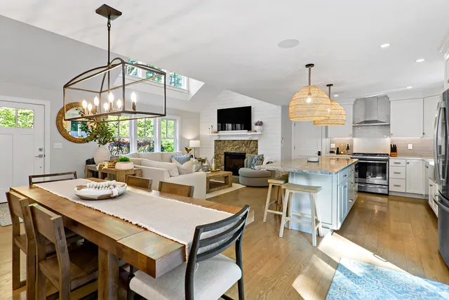 a view of a dining room with furniture a chandelier and wooden floor