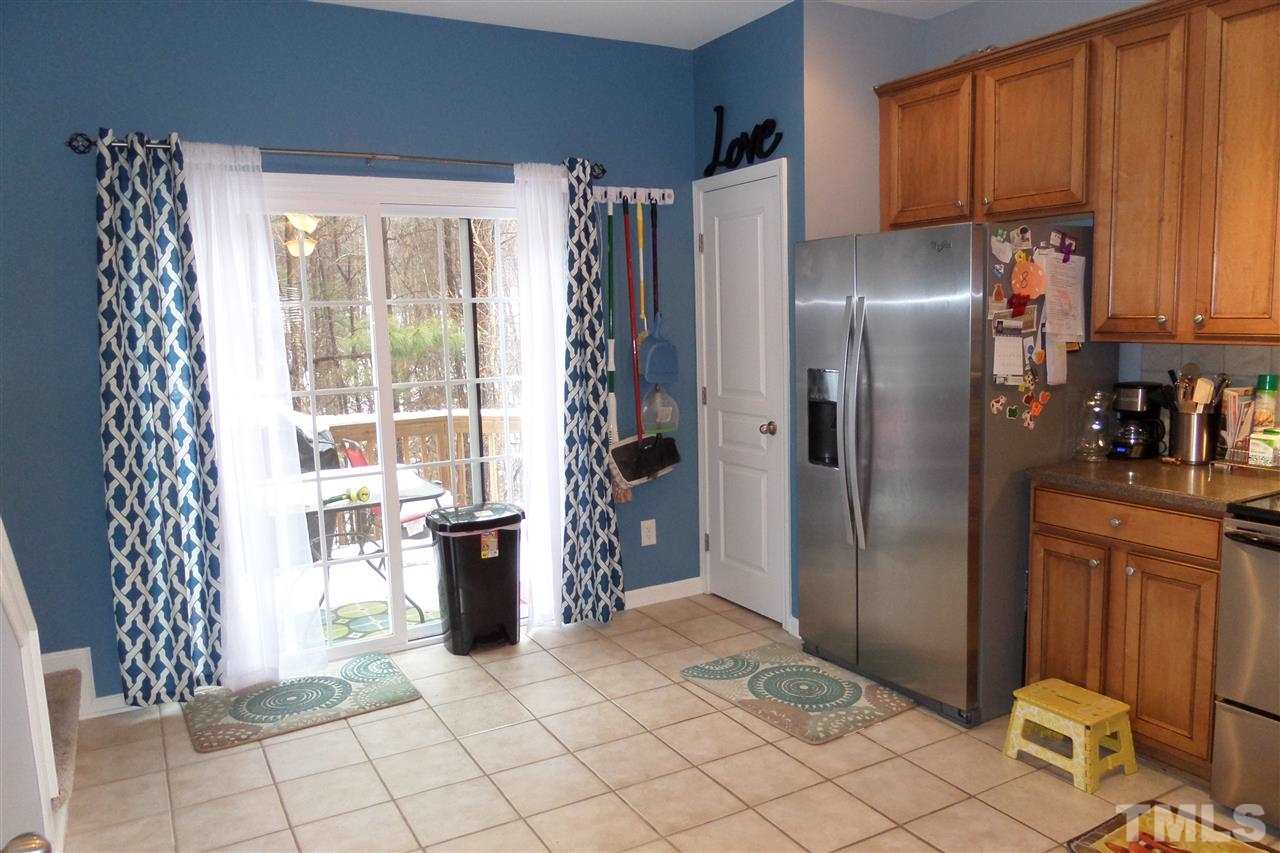 7872 Spungold Street Raleigh, NC 27617 - Photo 5 of 16 Kitchen with Ceramic tile leading to the deck