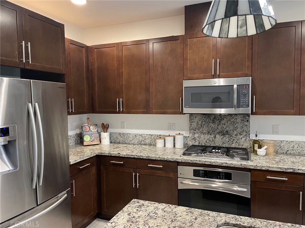 37 Soho Irvine, CA 92612 - Photo 9 of 21 a kitchen with a sink a refrigerator and cabinets