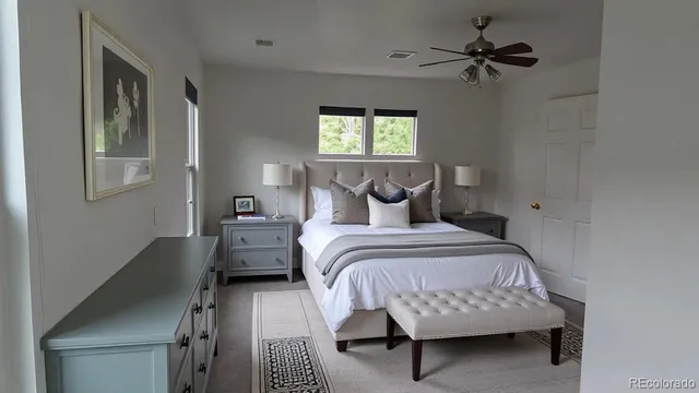 a bedroom with a bed a couch and a window