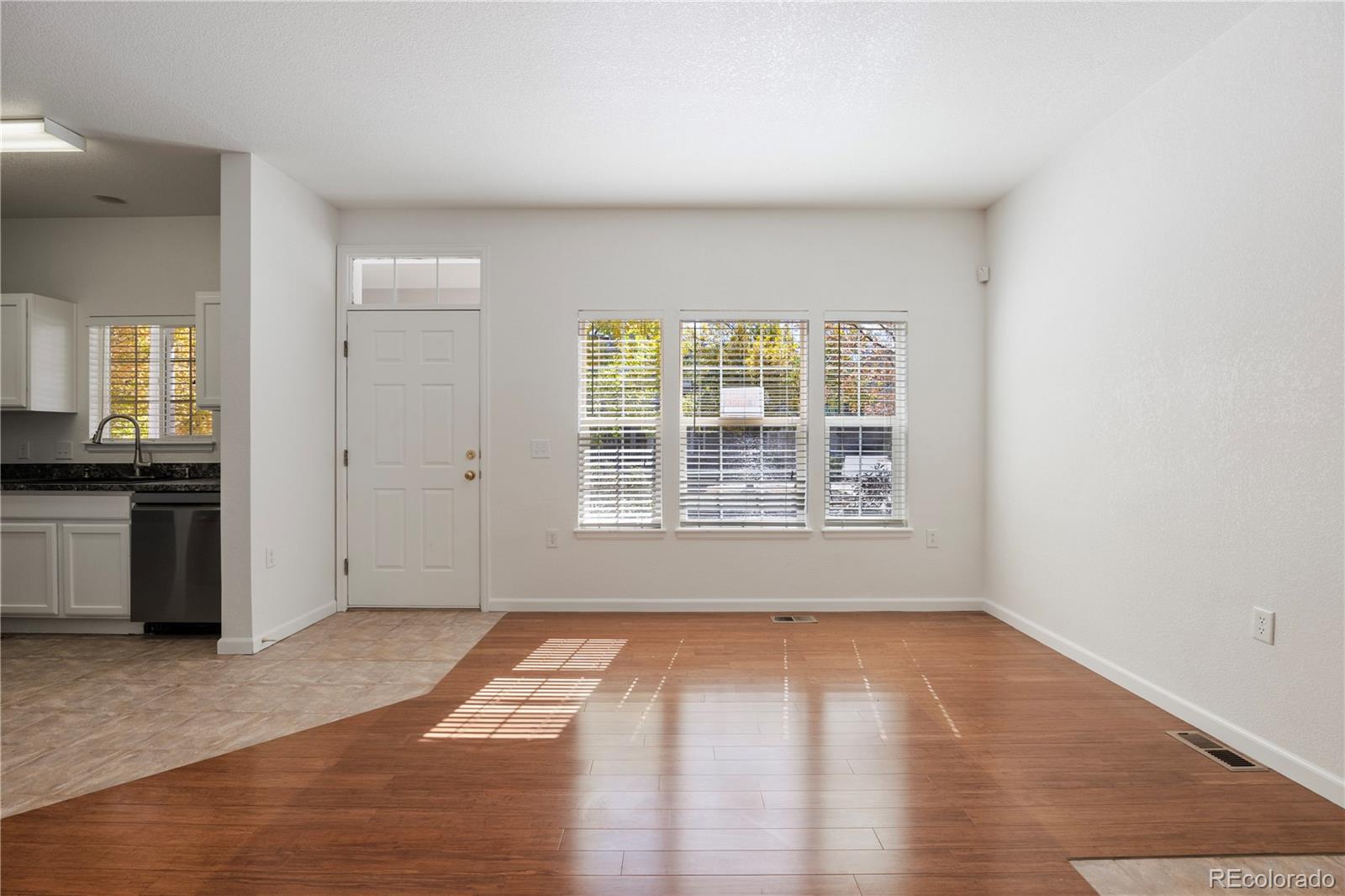 1480 Thunder Butte Road Castle Rock, CO 80109 - Photo 21 of 35 an empty room with wooden floor and windows