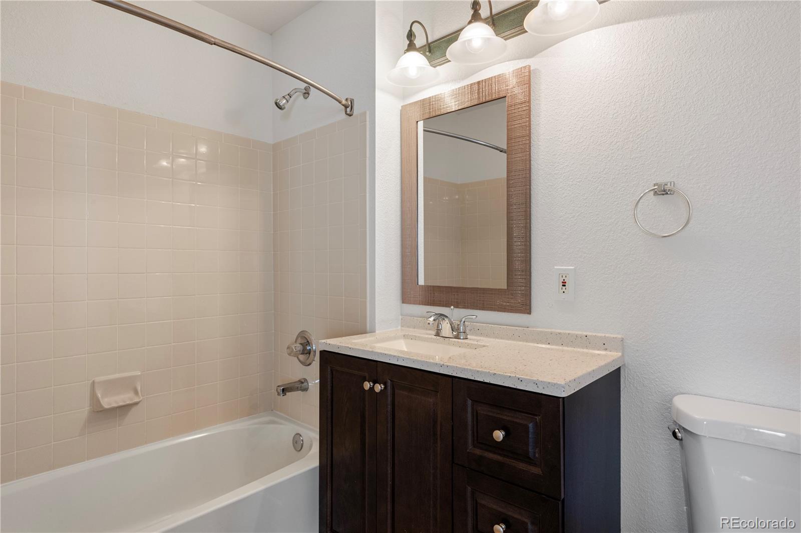 1480 Thunder Butte Road Castle Rock, CO 80109 - Photo 26 of 35 a bathroom with a sink vanity tub and a mirror