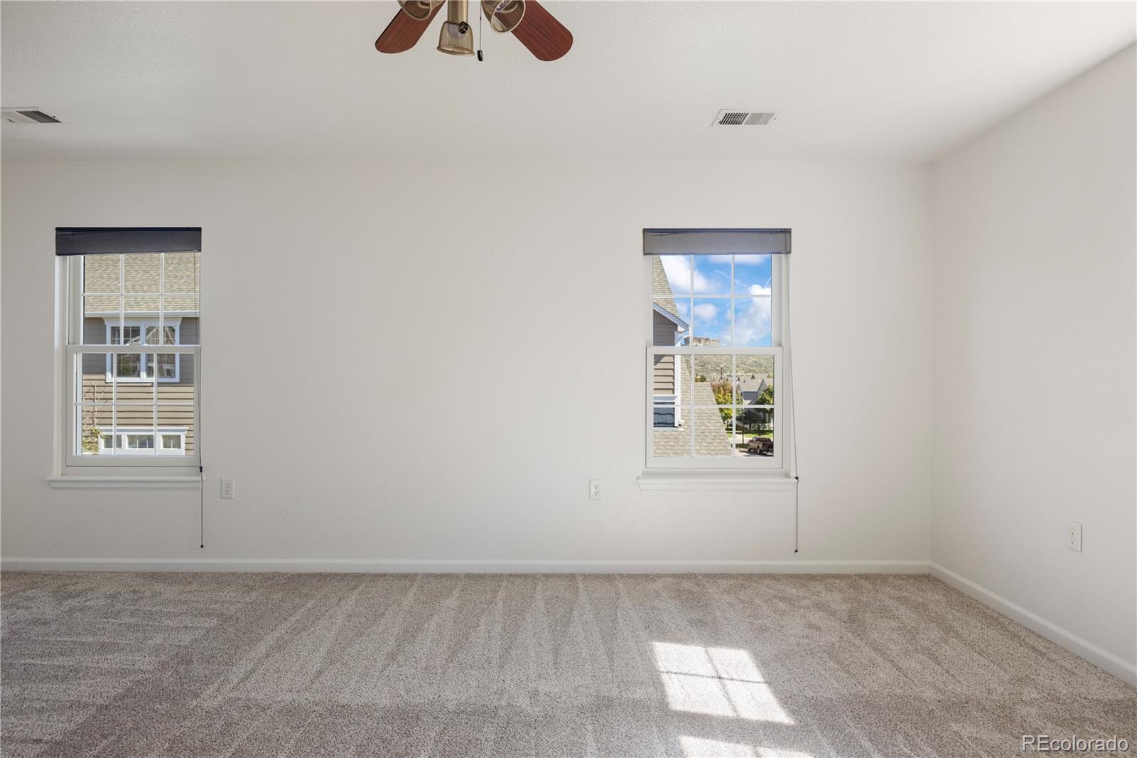 1480 Thunder Butte Road Castle Rock, CO 80109 - Photo 27 of 35 an empty room with windows and fan
