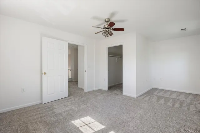 an empty room with a empty space and a ceiling fan