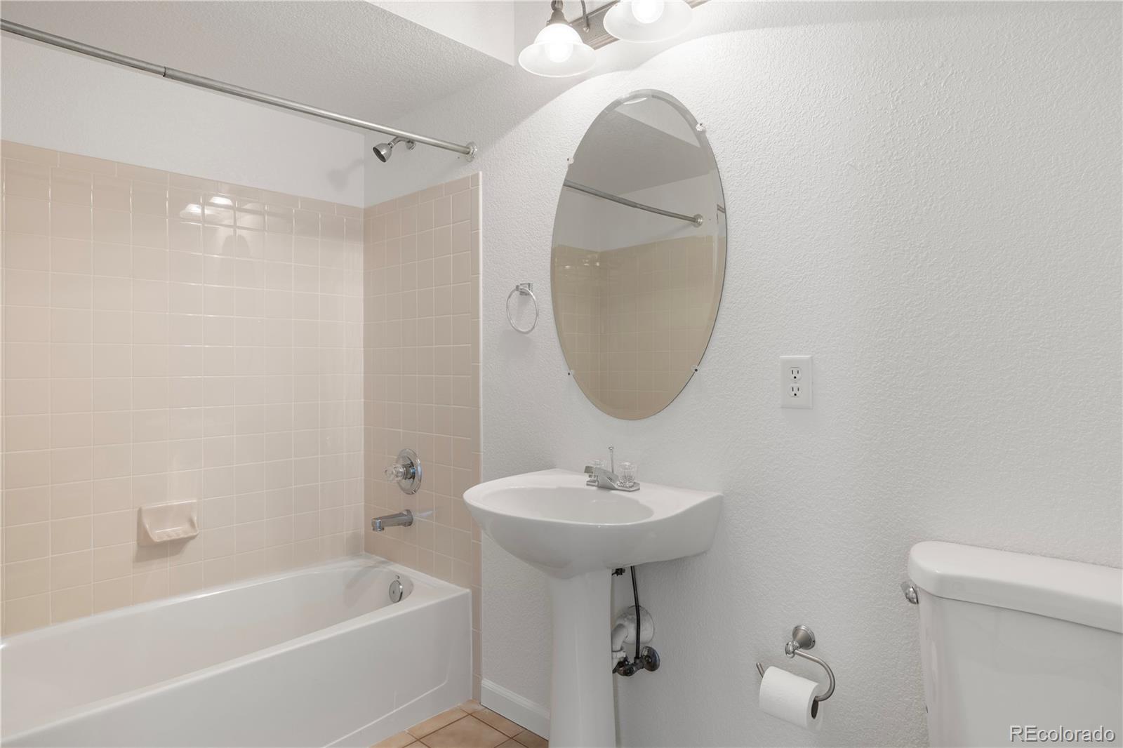 1480 Thunder Butte Road Castle Rock, CO 80109 - Photo 31 of 35 a bathroom with a sink a bathtub and a mirror