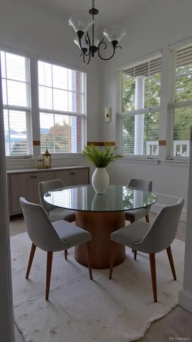 a living room with a table chairs and a window