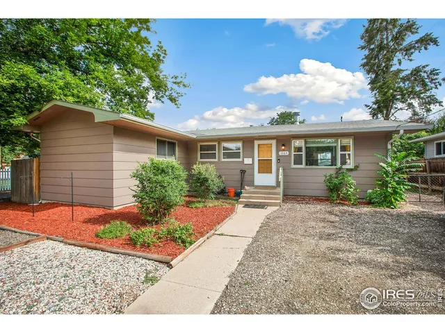 a backyard of a house with yard and outdoor seating