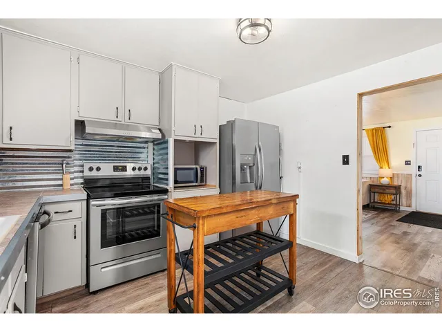 a kitchen with stainless steel appliances kitchen island a stove and a refrigerator