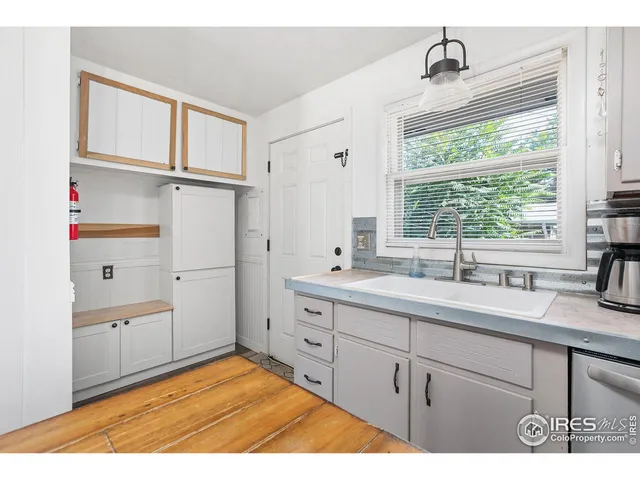 a kitchen with a sink cabinets and window