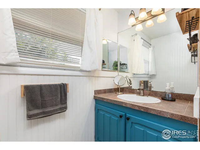 a bathroom with a sink a vanity and a mirror