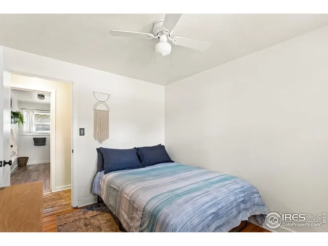 a bedroom with a bed and a ceiling fan