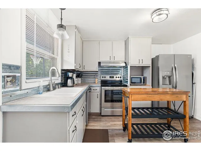 a kitchen with stainless steel appliances kitchen island granite countertop a sink and cabinets