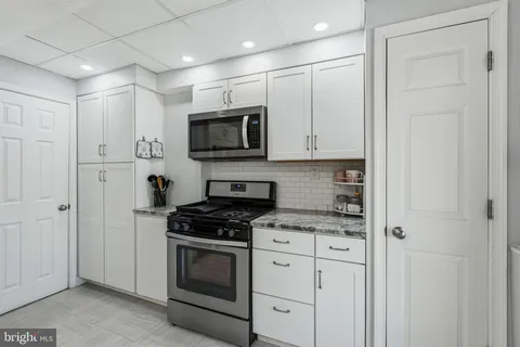 a view of a refrigerator in kitchen and entryway
